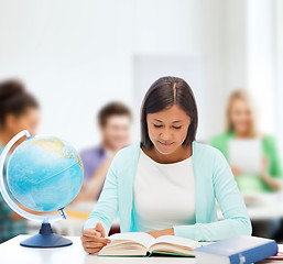 Image showing teacher with globe and book at school