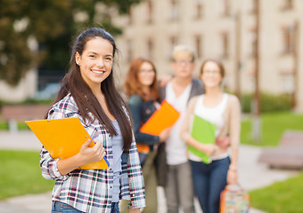 Image showing smiling female student with folders