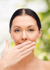 Image showing beautiful woman covering her mouth
