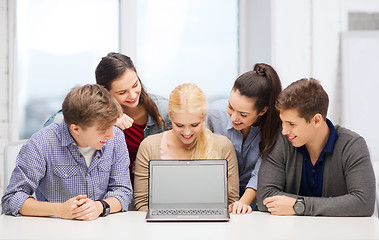 Image showing smiling students looking at blank lapotop screen