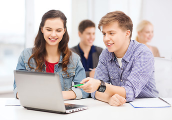 Image showing students with laptop and notebooks at school