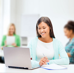 Image showing asian businesswoman with laptop and documents