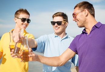 Image showing group of male friends having fun on the beach