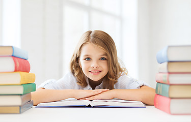 Image showing smiling little student girl with many books