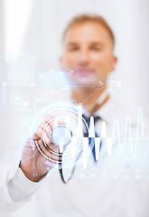 Image showing male doctor with stethoscope and cardiogram