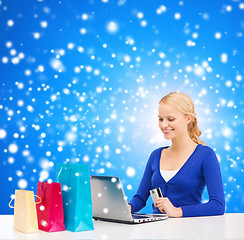 Image showing woman with laptop, shopping bags and credit card