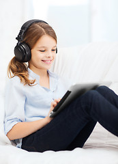 Image showing girl with tablet pc and headphones at home