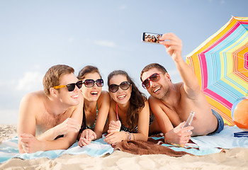 Image showing group of people taking picture with smartphone