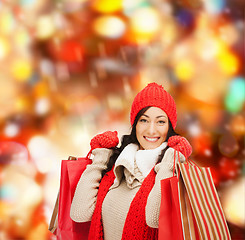 Image showing smiling woman in warm clothers with shopping bags