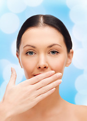 Image showing beautiful woman covering her mouth