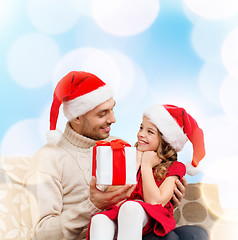 Image showing smiling father giving daughter gift box