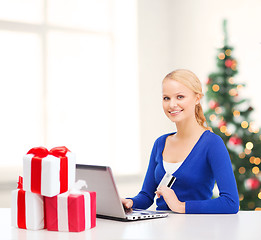 Image showing woman with gifts, laptop computer and credit card