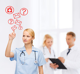 Image showing focused doctor or nurse pointing to red envelope