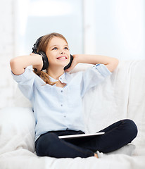 Image showing girl with tablet pc and headphones at home