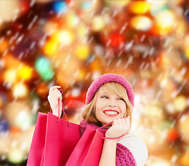 Image showing woman in pink hat and scarf with shopping bags