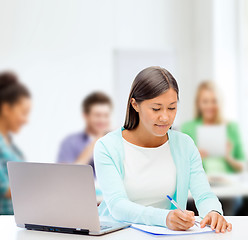 Image showing asian businesswoman with laptop and documents