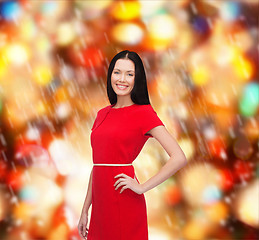 Image showing smiling young woman in red dress