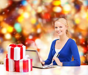 Image showing woman with gifts, laptop computer and credit card