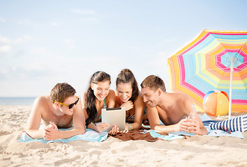 Image showing group of smiling people with tablet pc on beach