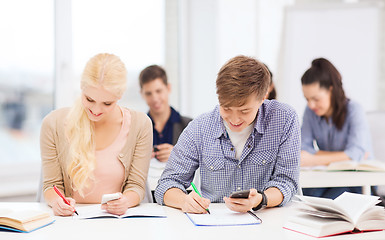 Image showing students looking into smartphone at school