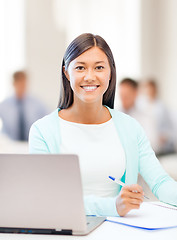 Image showing asian businesswoman with laptop and documents