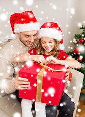 Image showing smiling father and daughter opening gift box