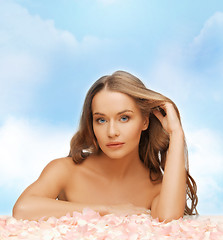 Image showing beautiful woman with long hair and rose petals