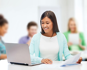 Image showing asian businesswoman with laptop and documents