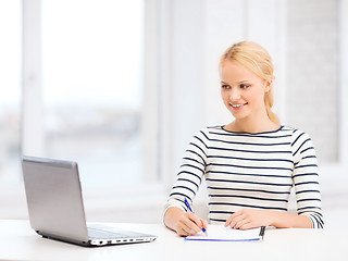 Image showing smiling student with laptop computer and documents