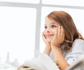 Image showing student girl writing in notebook at school