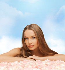 Image showing beautiful woman with long hair and rose petals