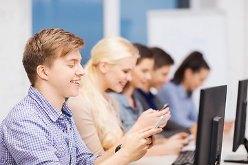 Image showing students with computer monitor and smartphones