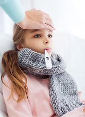 Image showing ill girl child with thermometer and caring mother