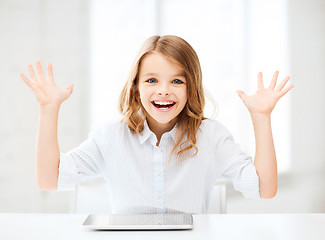 Image showing laughing girl with tablet pc computer and hands up