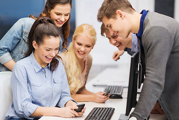 Image showing students with computer monitor and smartphones