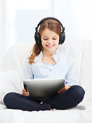 Image showing girl with tablet pc and headphones at home