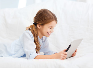 Image showing smiling girl with tablet computer at home