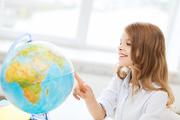 Image showing smiling student girl with globe at school