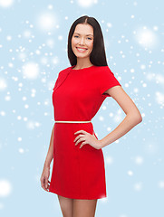 Image showing smiling young woman in red dress