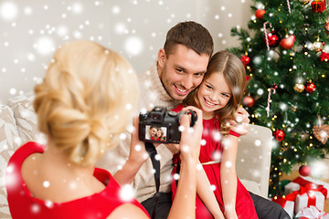 Image showing mother taking picture of father and daughter