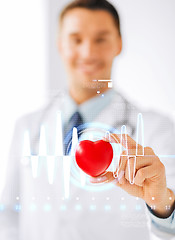 Image showing male doctor with heart and cardiogram