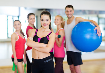 Image showing woman standing in front of the group in gym