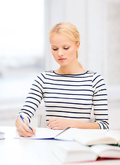 Image showing concentrated woman studying in college