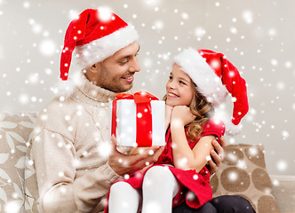 Image showing smiling father giving daughter gift box