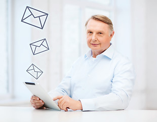 Image showing old man with tablet computer at home