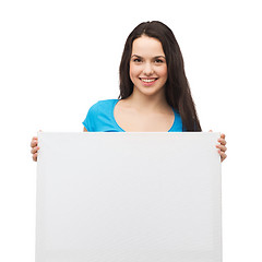 Image showing smiling young girl with blank white board