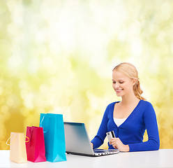 Image showing woman with laptop, shopping bags and credit card