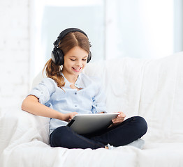 Image showing girl with tablet pc and headphones at home