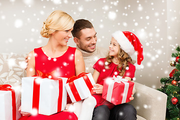 Image showing smiling family holding many gift boxes