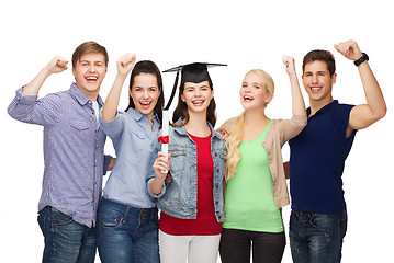 Image showing group of standing smiling students with diploma